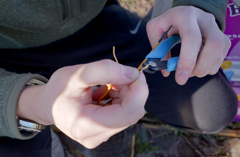 Edward Ge makes adjustments to the wires